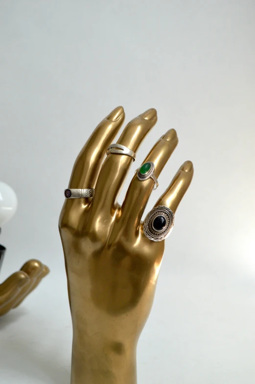 a hand made of metal with rings on it