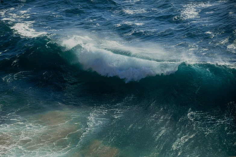 a large wave is crashing in the ocean