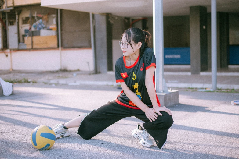 a woman holding on to a yellow and blue ball