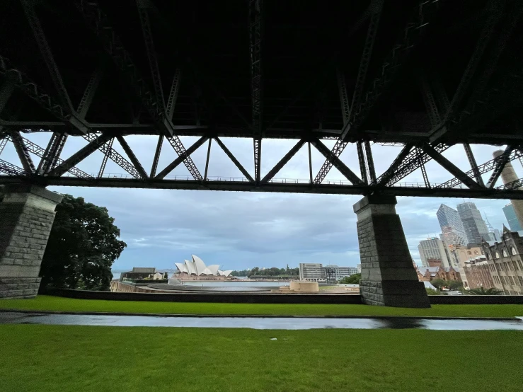 a park with lots of benches under a bridge