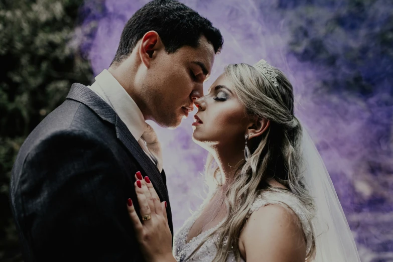 the bride and groom emce with their wedding makeup on their forehead