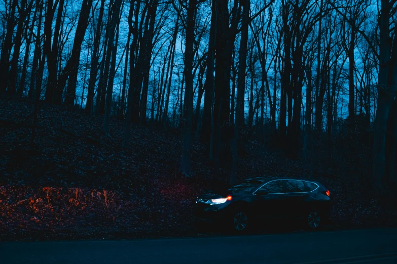 an image of a car driving down the road in the night time