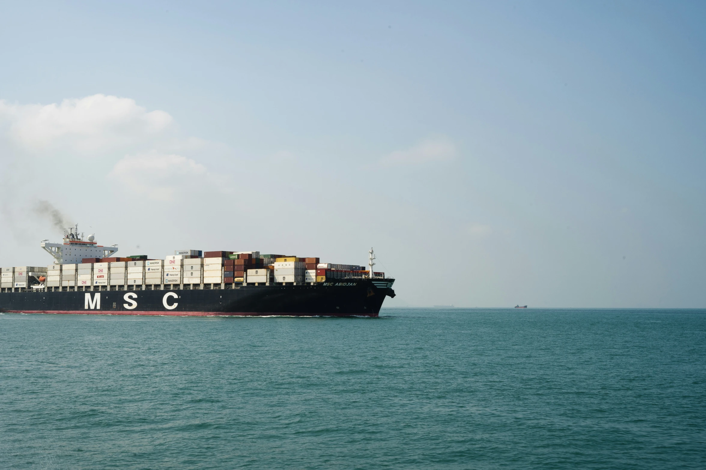 a large cargo ship with lots of containers on its back