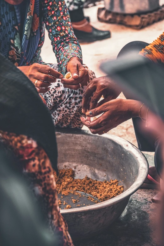 four people are taking samples and getting food from a bowl