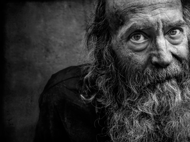 a old man with a beard and long beard, looking into the camera