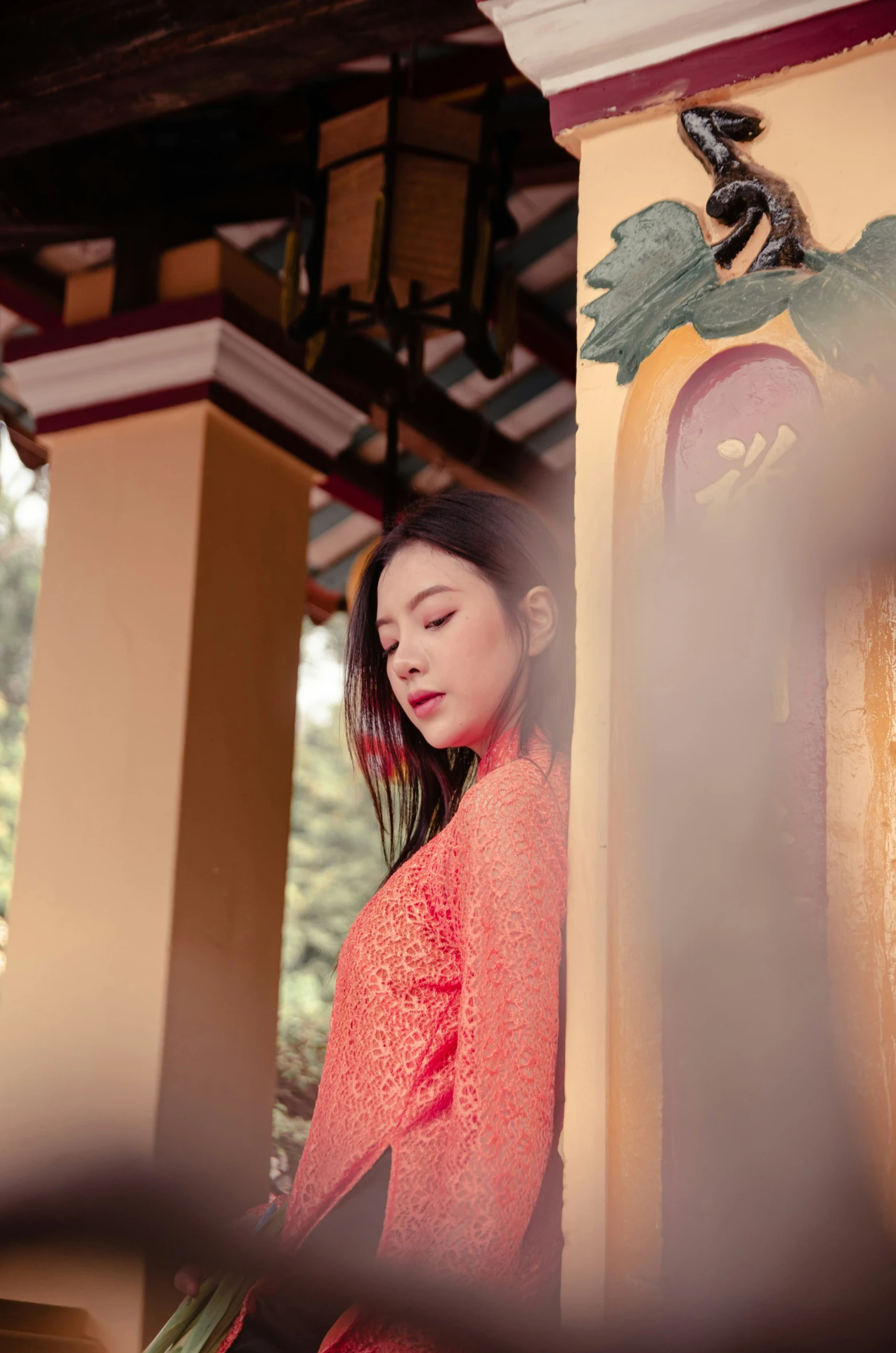 a girl in red standing outside near a building