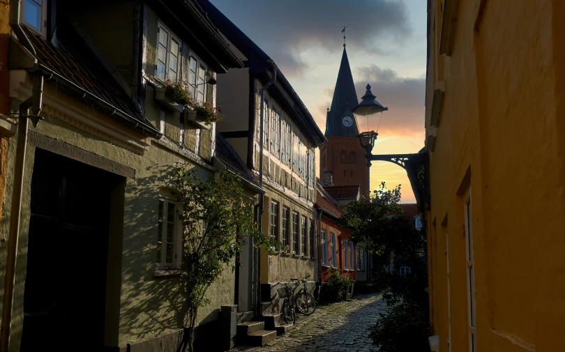 the narrow alleys have cobblestones and a clock tower