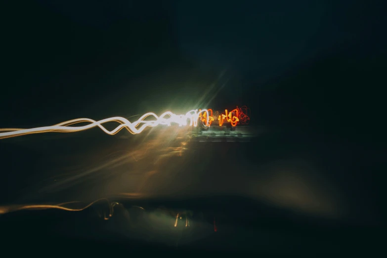 a night view of cars driving in the dark with long exposure