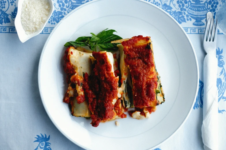 a white plate topped with meat covered in sauce