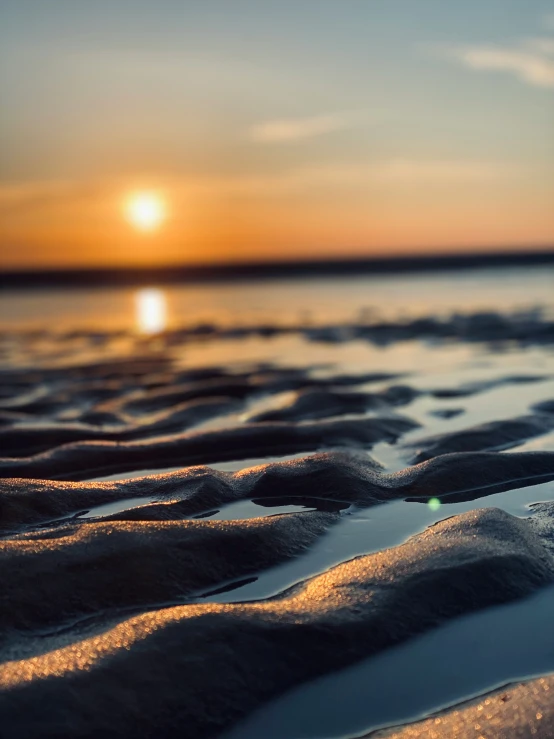 the sun is setting over a body of water