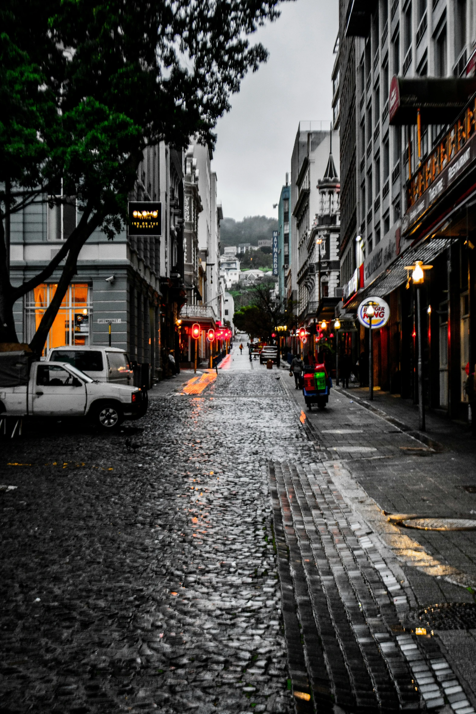 a city street with cars on it next to some tall buildings