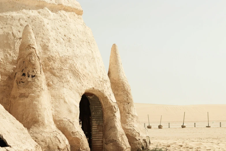 a small building made of rocks with a tower