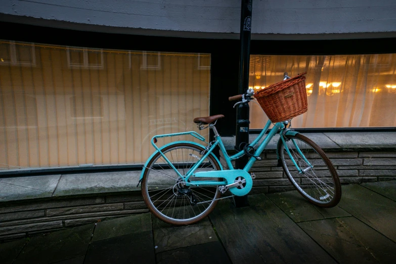 a blue bike parked next to a parking meter