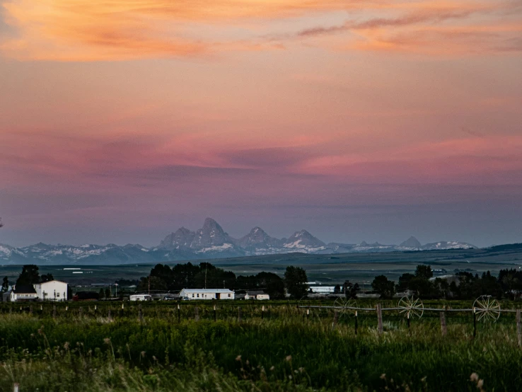 an image of a scenic sunset over a farm area