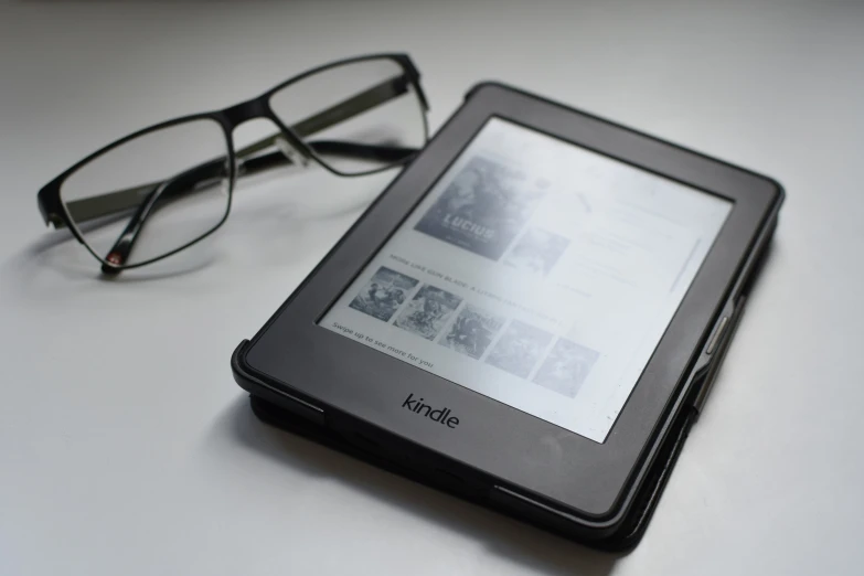 a tablet on top of a table next to glasses