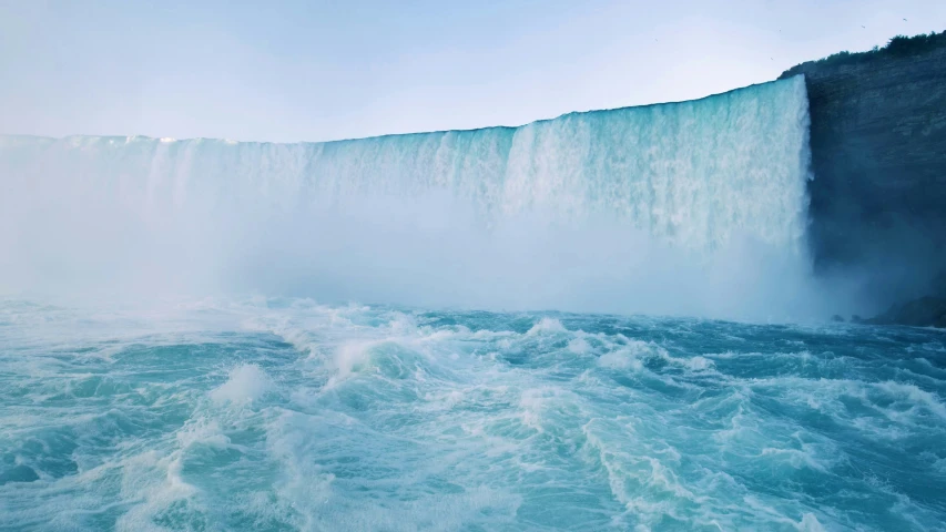 the waterfall is full of water and large rocks