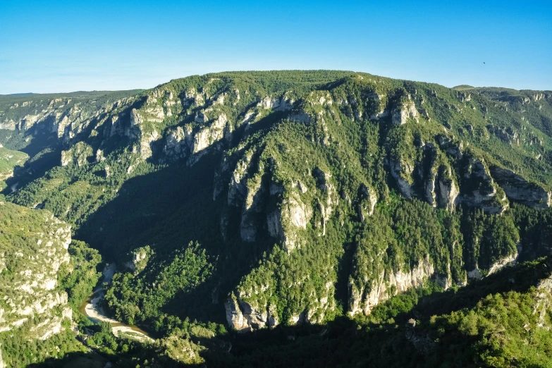 the view from above of a mountain showing a wide valley