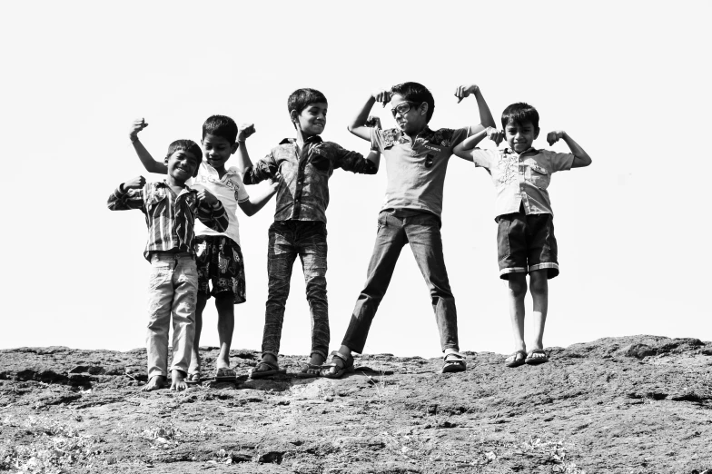 three children are making faces while holding their hands up in the air