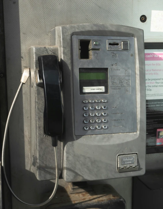 an old and worn telephone has a time card and no numbers on it