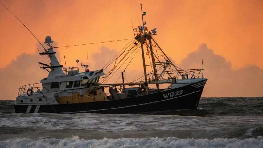 the large fishing boat is out on the choppy water