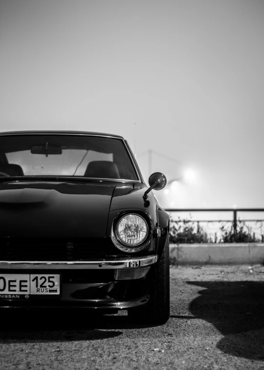 the back end of a black car parked on the road