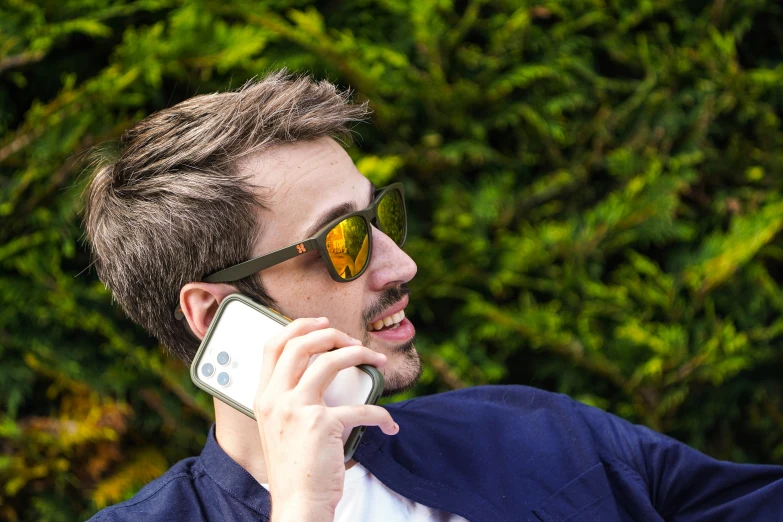 a man in shades is on the phone