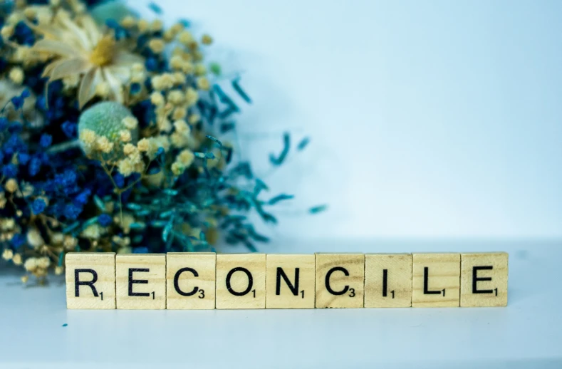 a scrabbled wooden block spelling rectangle surrounded by flowers