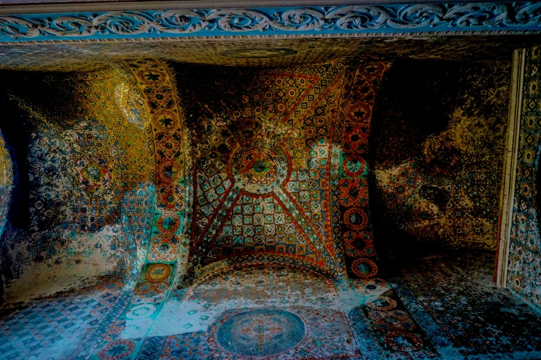 a colorful tapestry is covering a bed in an ornate room