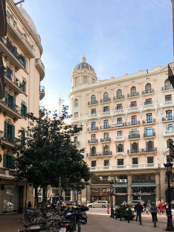 several people on bicycles are parked near two buildings