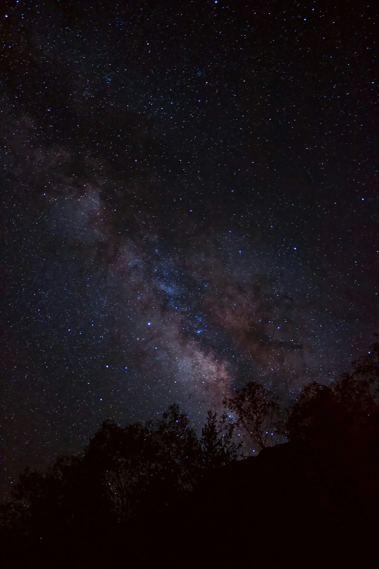 the night sky filled with lots of stars and bright light