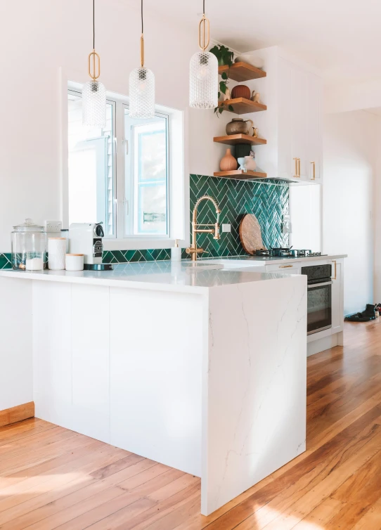 a kitchen with white cabinets and an island