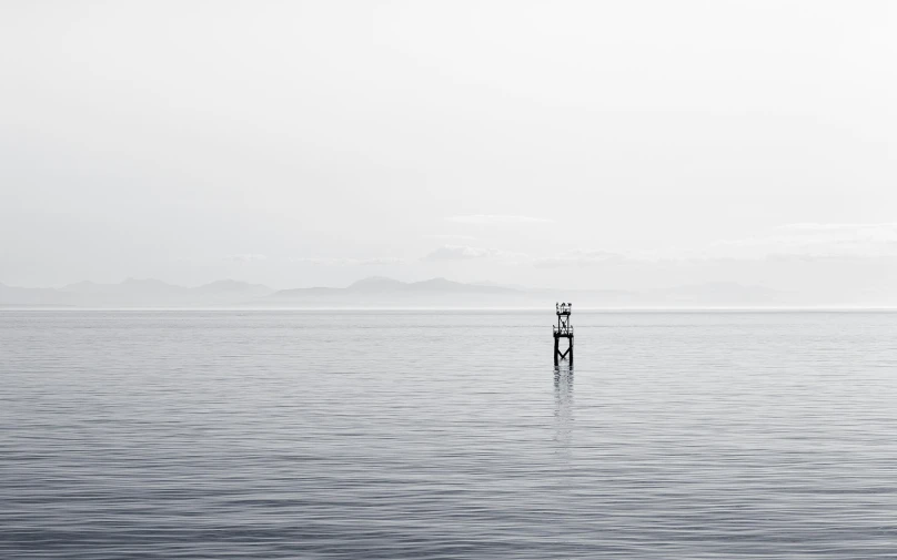 a black and white po with a man standing on a boat