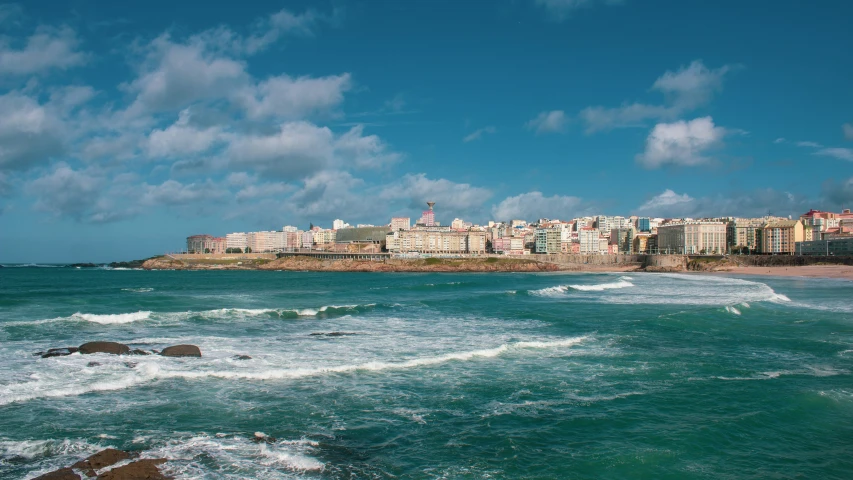 a city skyline sits over the ocean in the background