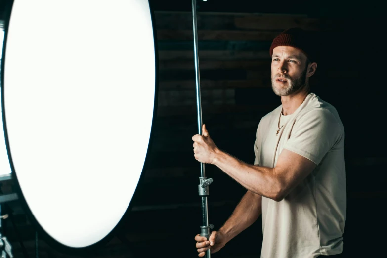 a man is lighting a light in a studio