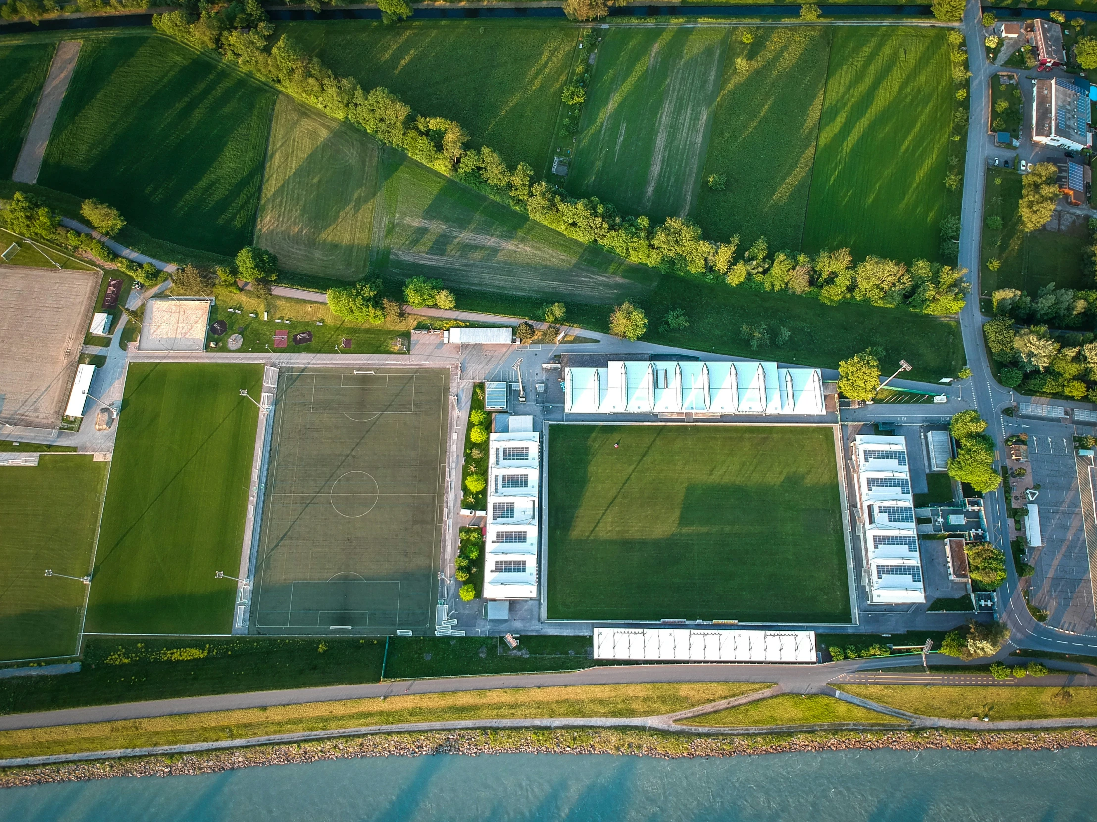 an aerial view of a grassy area surrounded by buildings