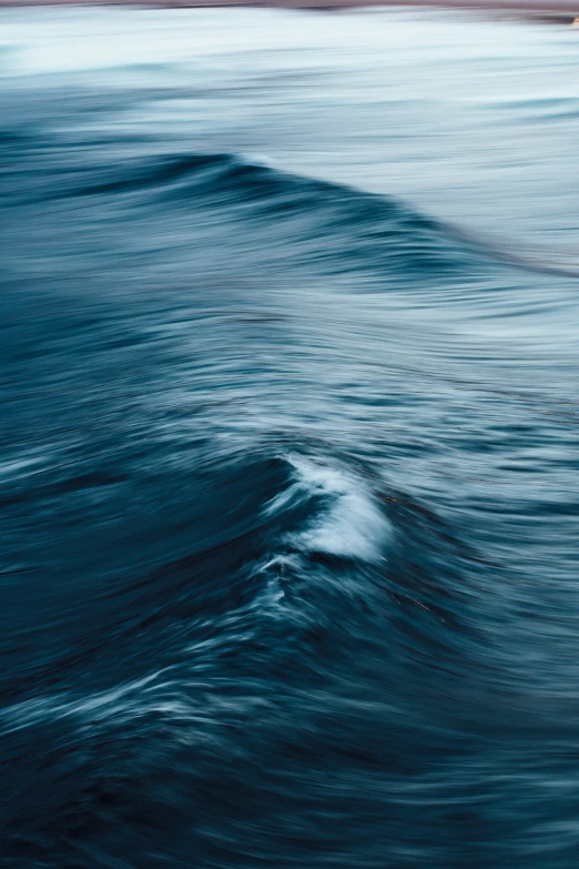 waves in blue water moving close together on top of each other