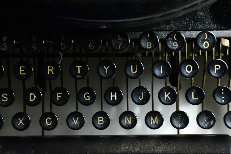 a black typewriter that has several type of letters on it