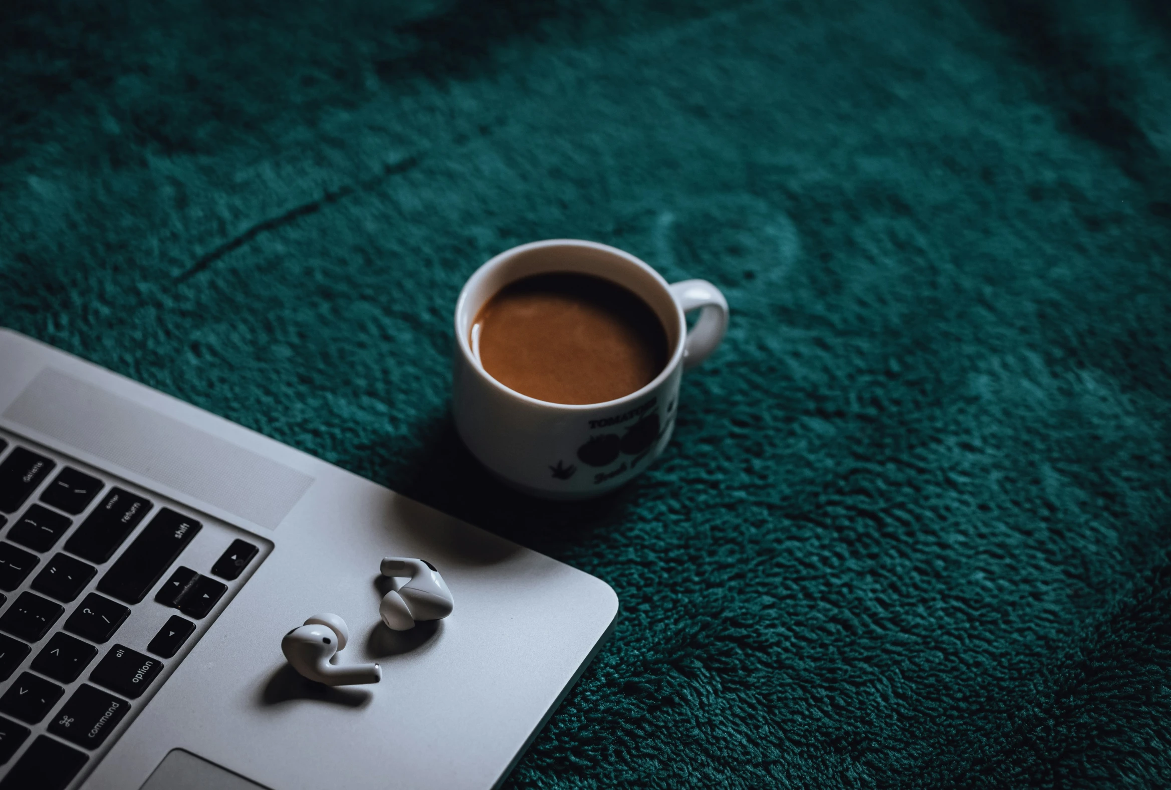 a cup of coffee is next to a laptop