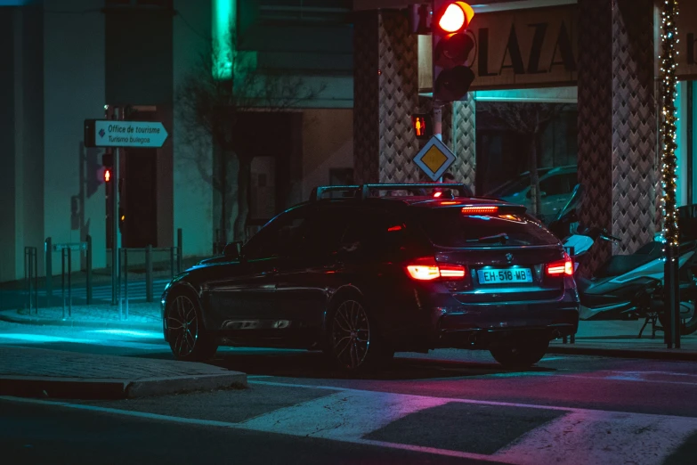 a car parked at a stoplight on a street