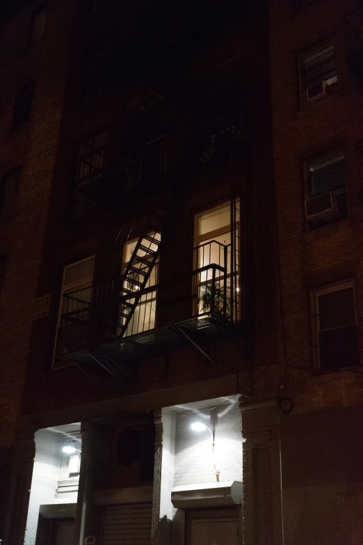 two fire escapes lit up in the windows