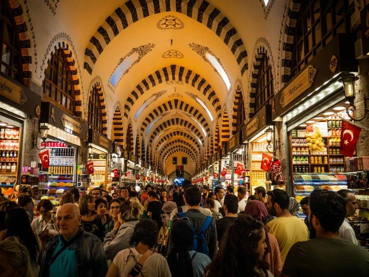 an indoor covered market with many people