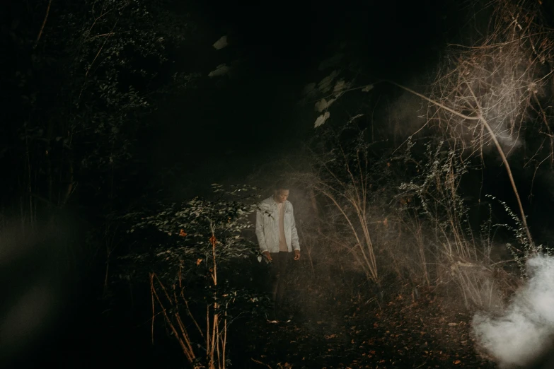 a creepy picture of a man standing in the forest