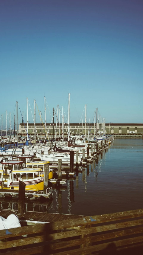 boats are parked at a pier by the shore