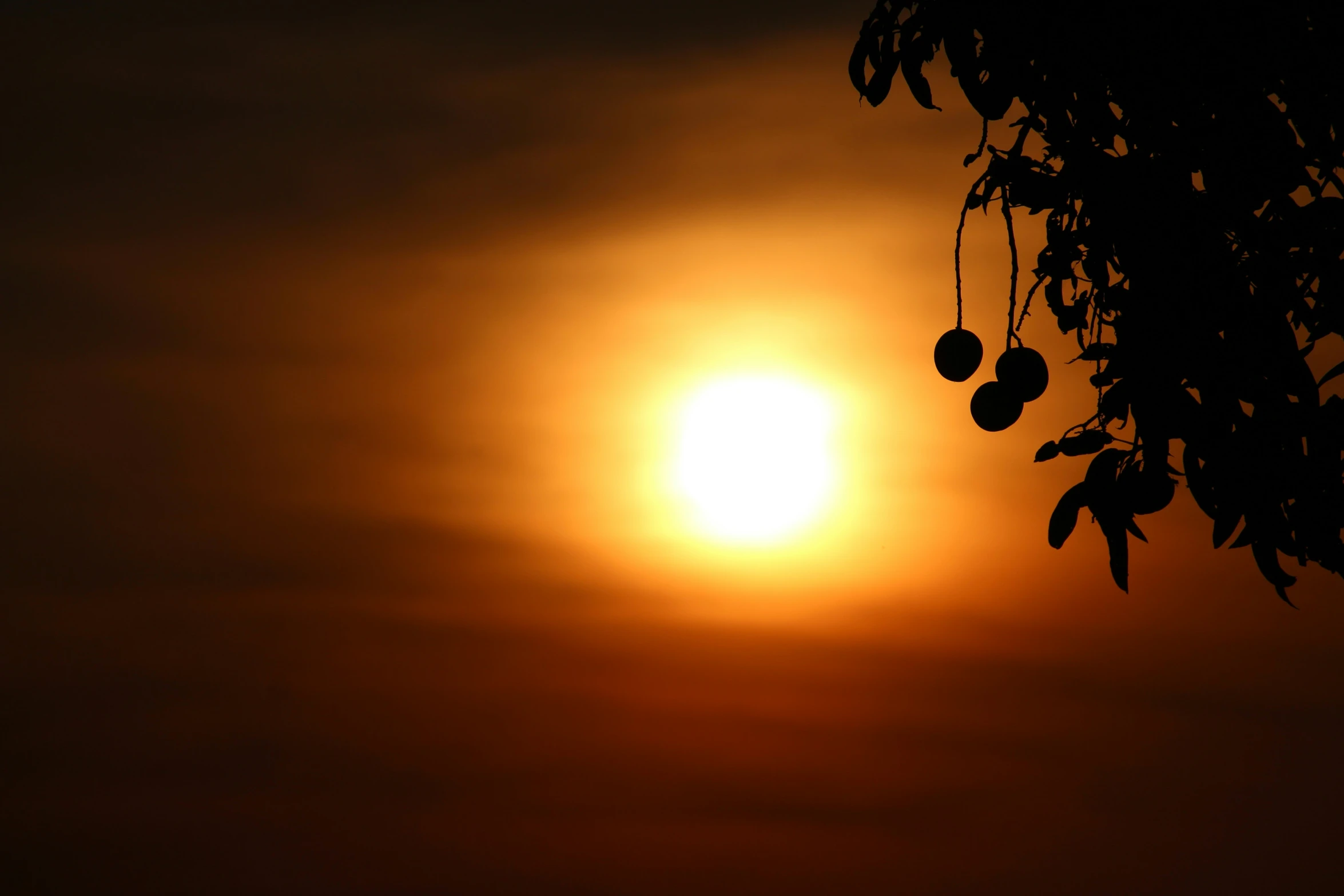 the sun is rising with the clouds behind it