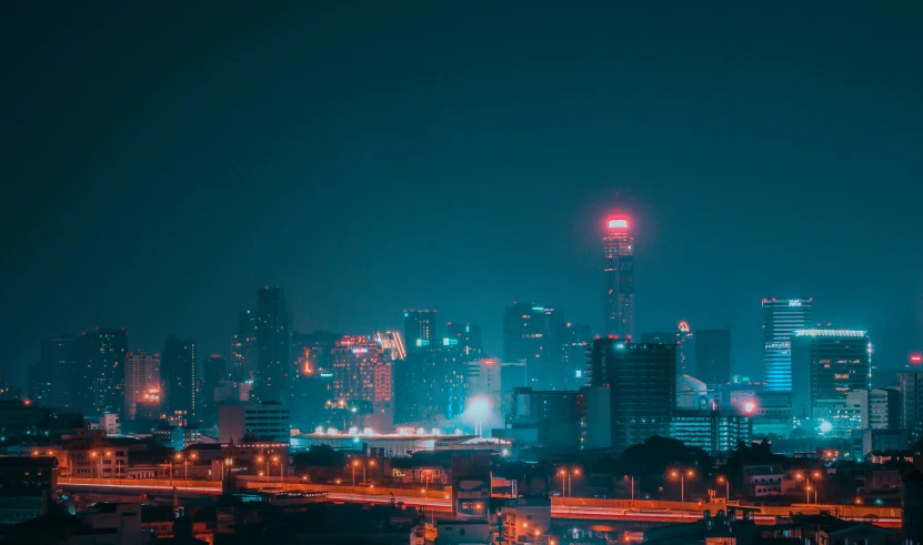 city skyline with skyscrs and traffic lights at night