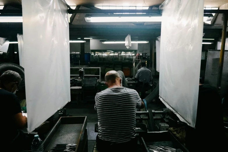 a man works in a glass factory making glasses