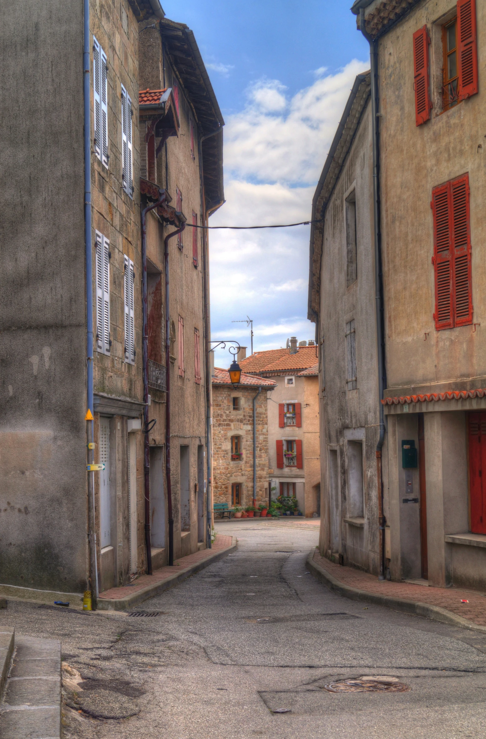 two buildings sit in the middle of an old street