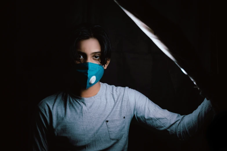 a woman with a face mask and a blue knife