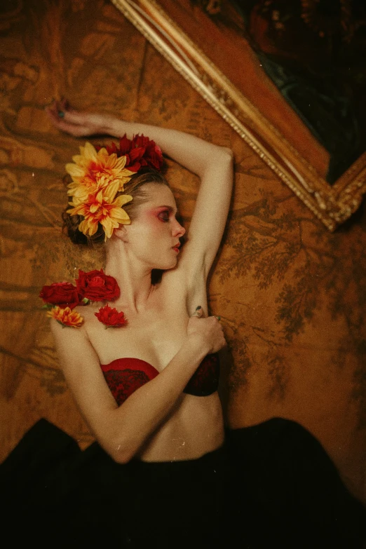 a woman wearing flowers and in lingerie sitting on a bed