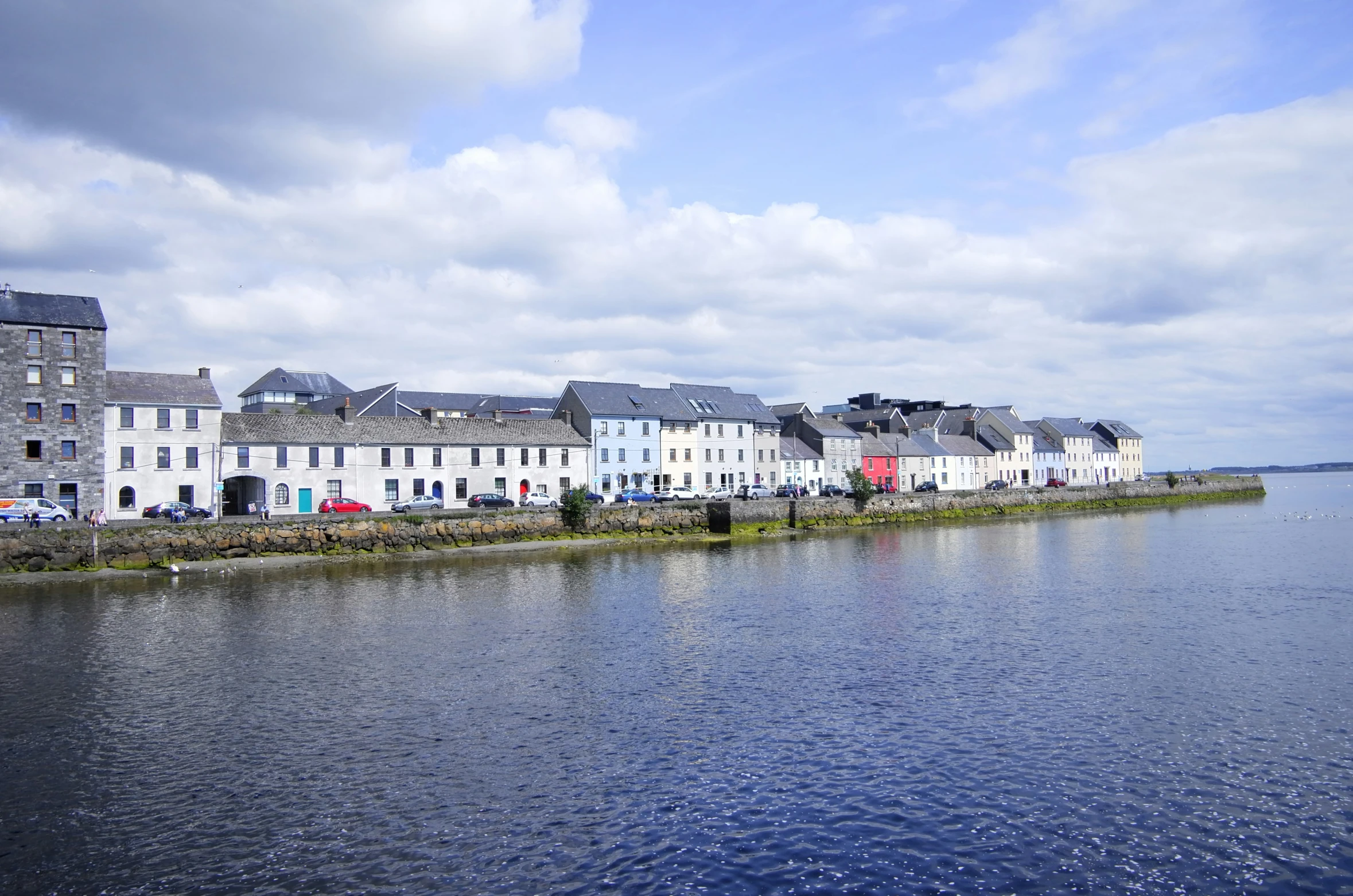 a row of buildings along the shore line